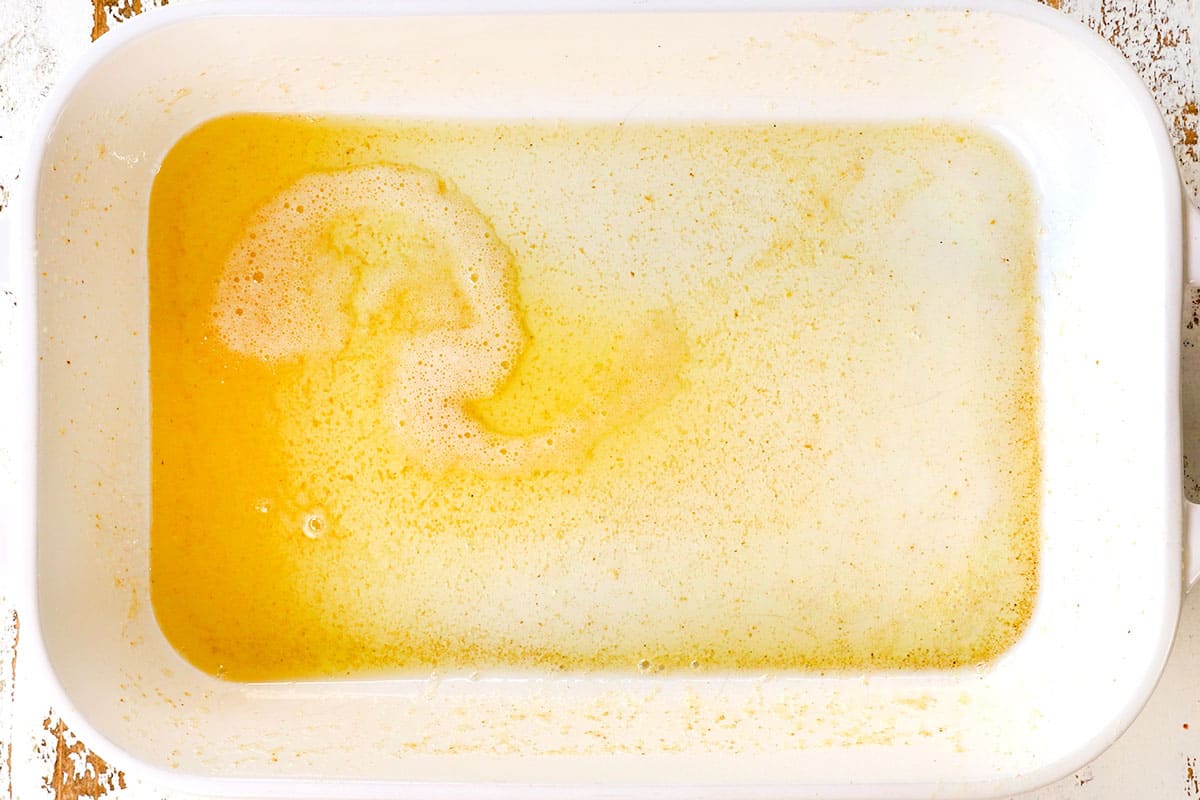 showing how to make German Pancakes by melting butter in a 9x13 pan