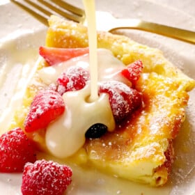 showing how to serve German pancakes by pouring syrup over a slice