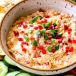 showing how to serve pimento cheese recipe adding to a platter with cucumbers, celery, bell peppers, cauliflower and crackers
