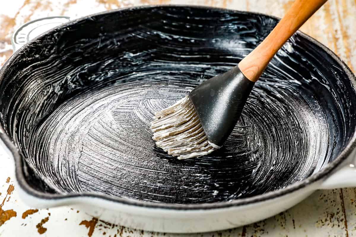 showing how to make s'mores dip recipe by greasing pan with butter