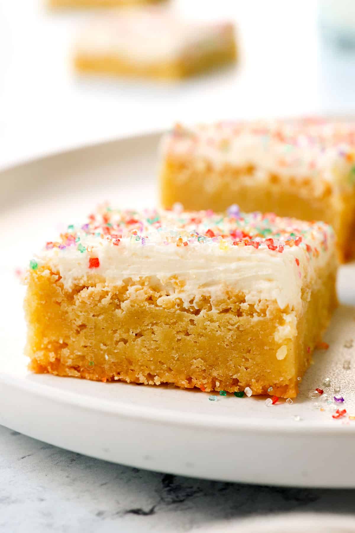 showing how to serve sugar cookie bars recipe on a plate