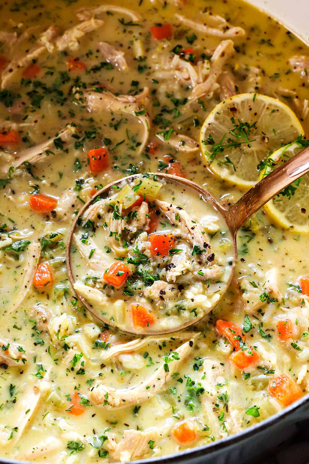 a ladle of Avgolemono Soup (Greek Lemon Chicken Soup) showing how silky it is