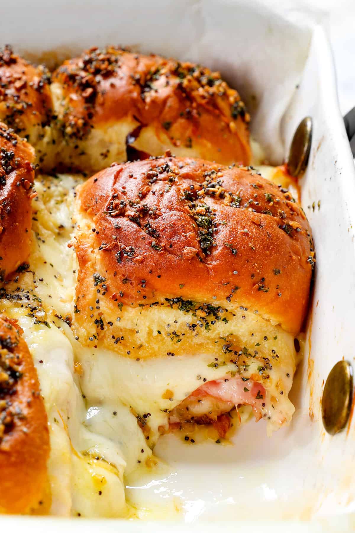 up close of hot ham and cheese sliders showing how cheesy they are