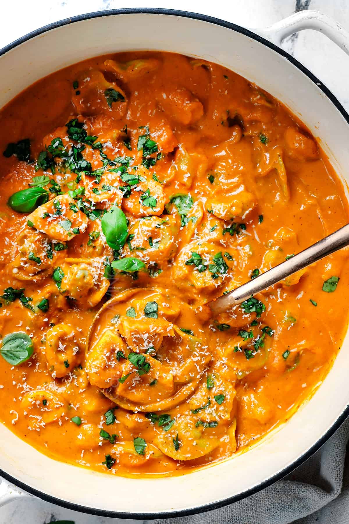 showing how to make tomato tortellini soup recipe by cooking tortellini in the soup