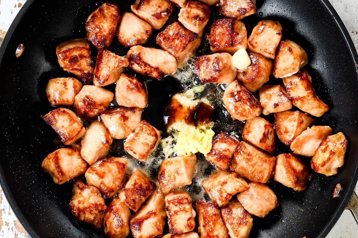 showing how to make hibachi chicken recipe y searing chicken, then adding butter, garlic and ginger