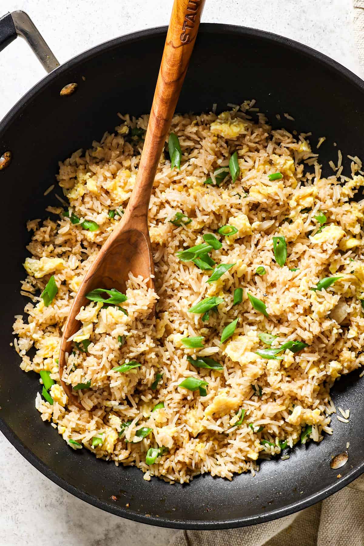 showing how to make hibachi chicken by stirring in green onions