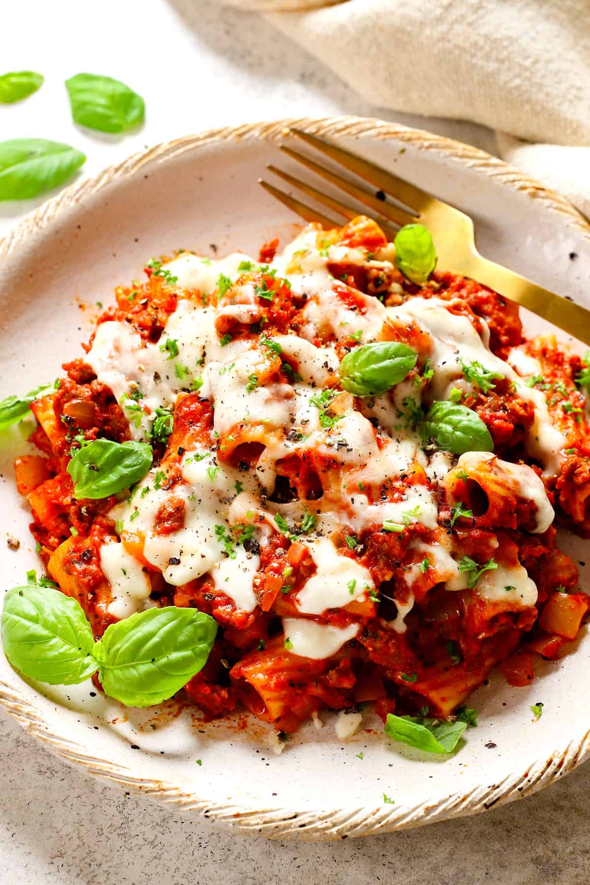 baked rigatoni recipe on a plate topped with cheese