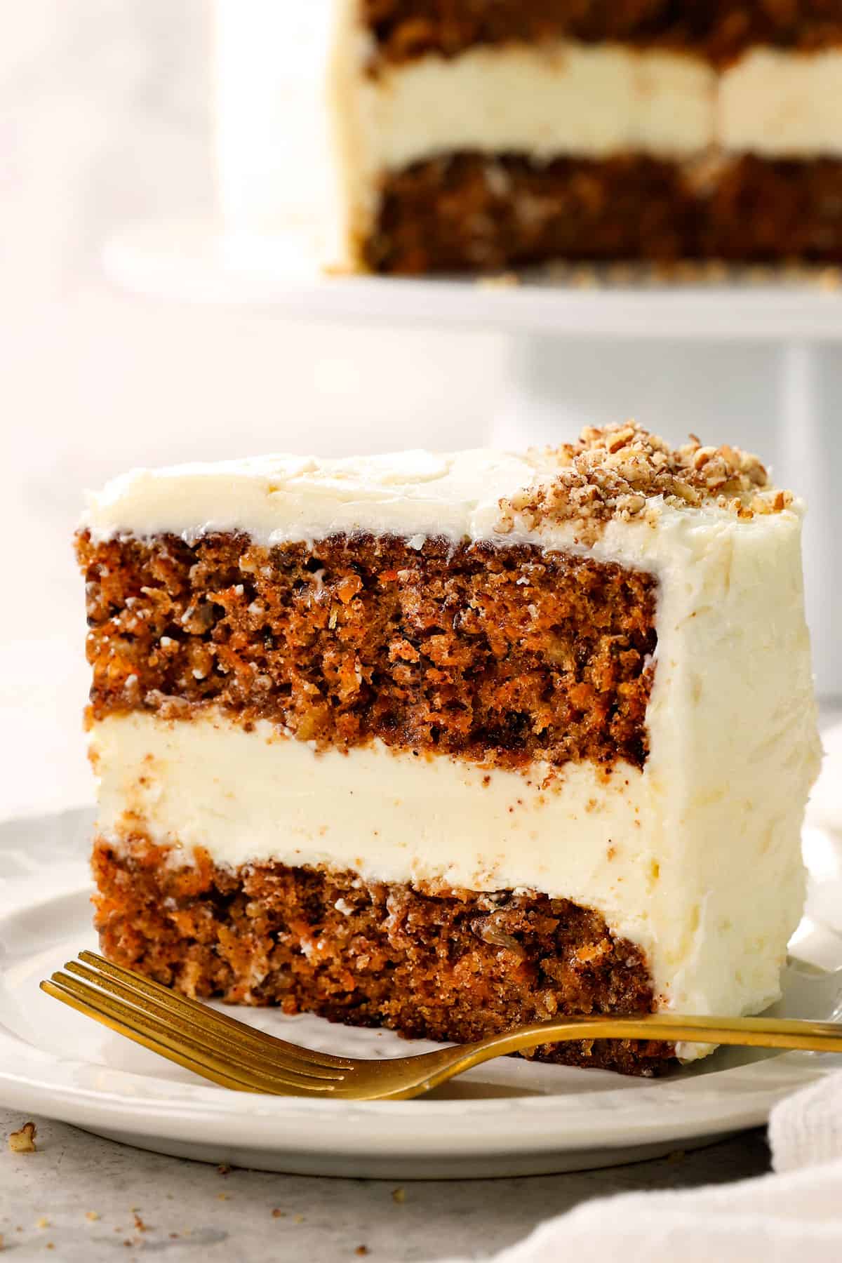 up close of carrot cake cheesecake showing how moist the cake is and how creamy the cheesecake is