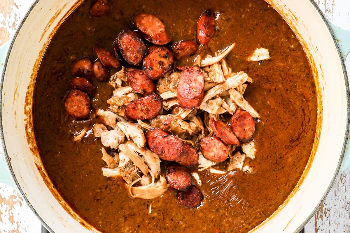 showing how to make gumby by adding chicken and sausage to the soup to simmer