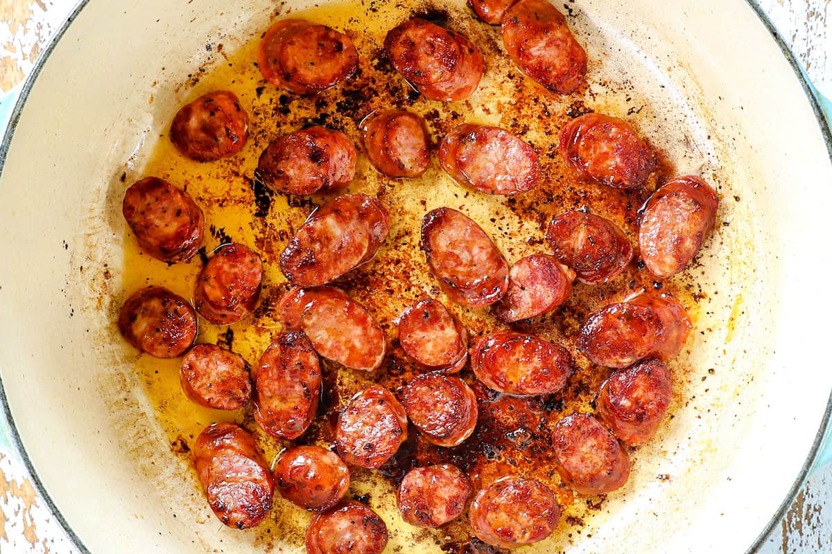 showing how to make gumbo by searing the sausage in a Dutch oven
