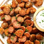 top view of serving crispy Parmesan Crusted potatoes with herb sauce