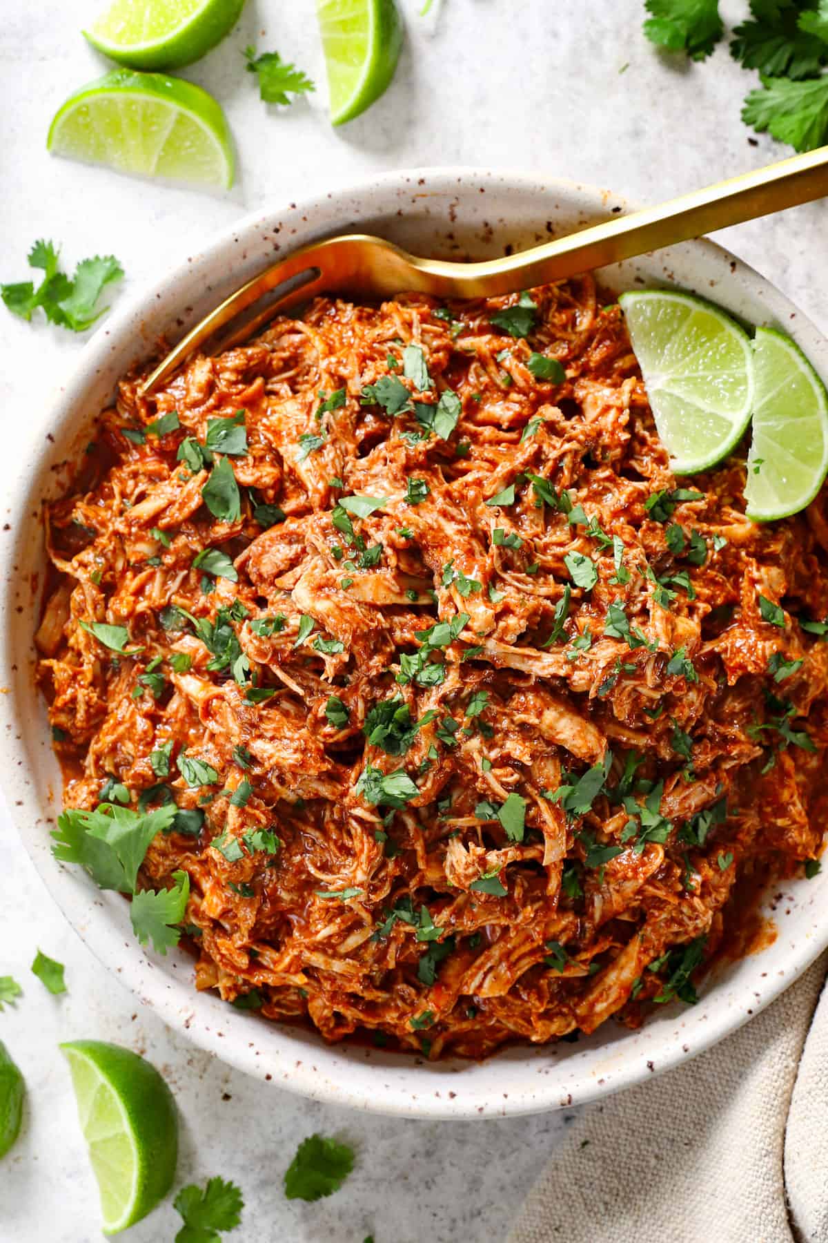 showing how to make baked chicken tacos by starting off with shredded Mexican chicken
