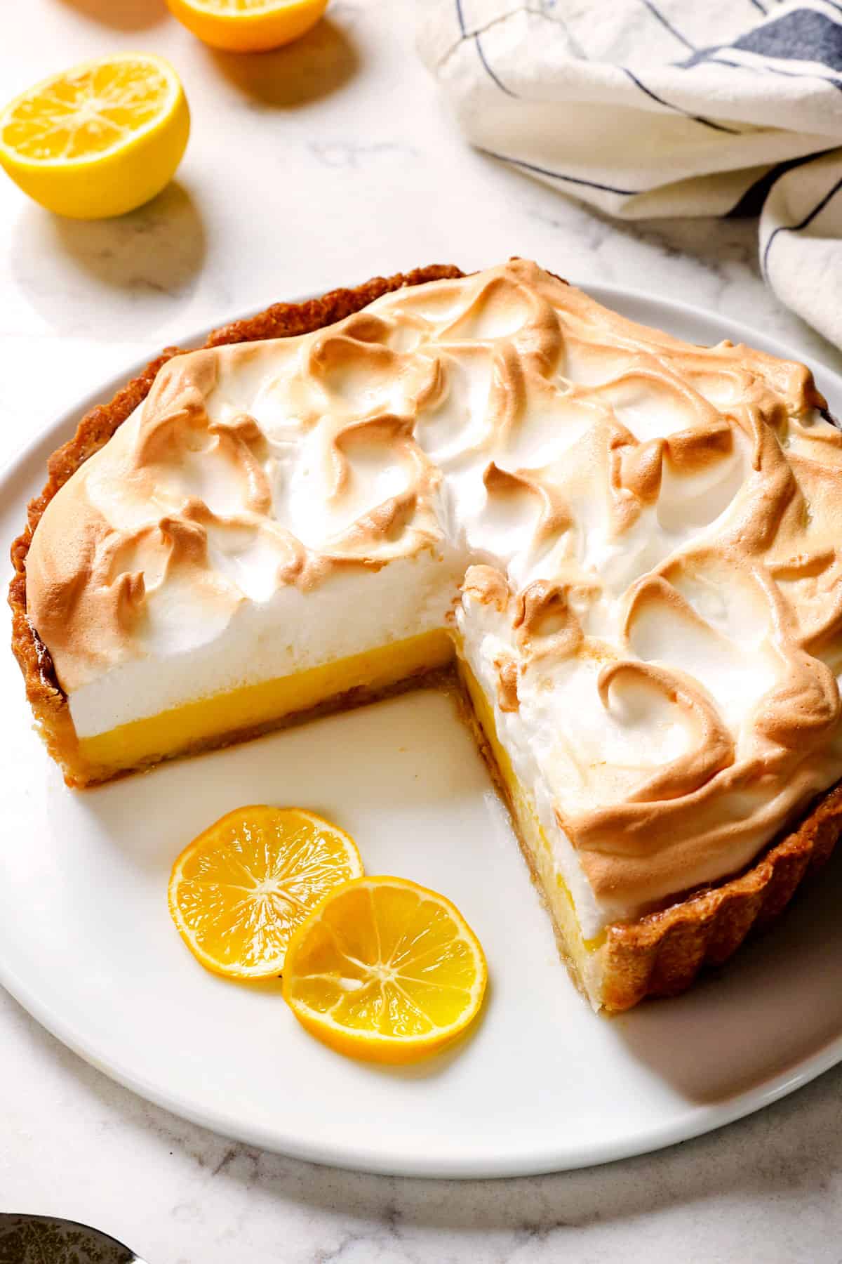Easy Lemon Meringue Pie on a platter showing the beautifully lemon filling and toasted meringue