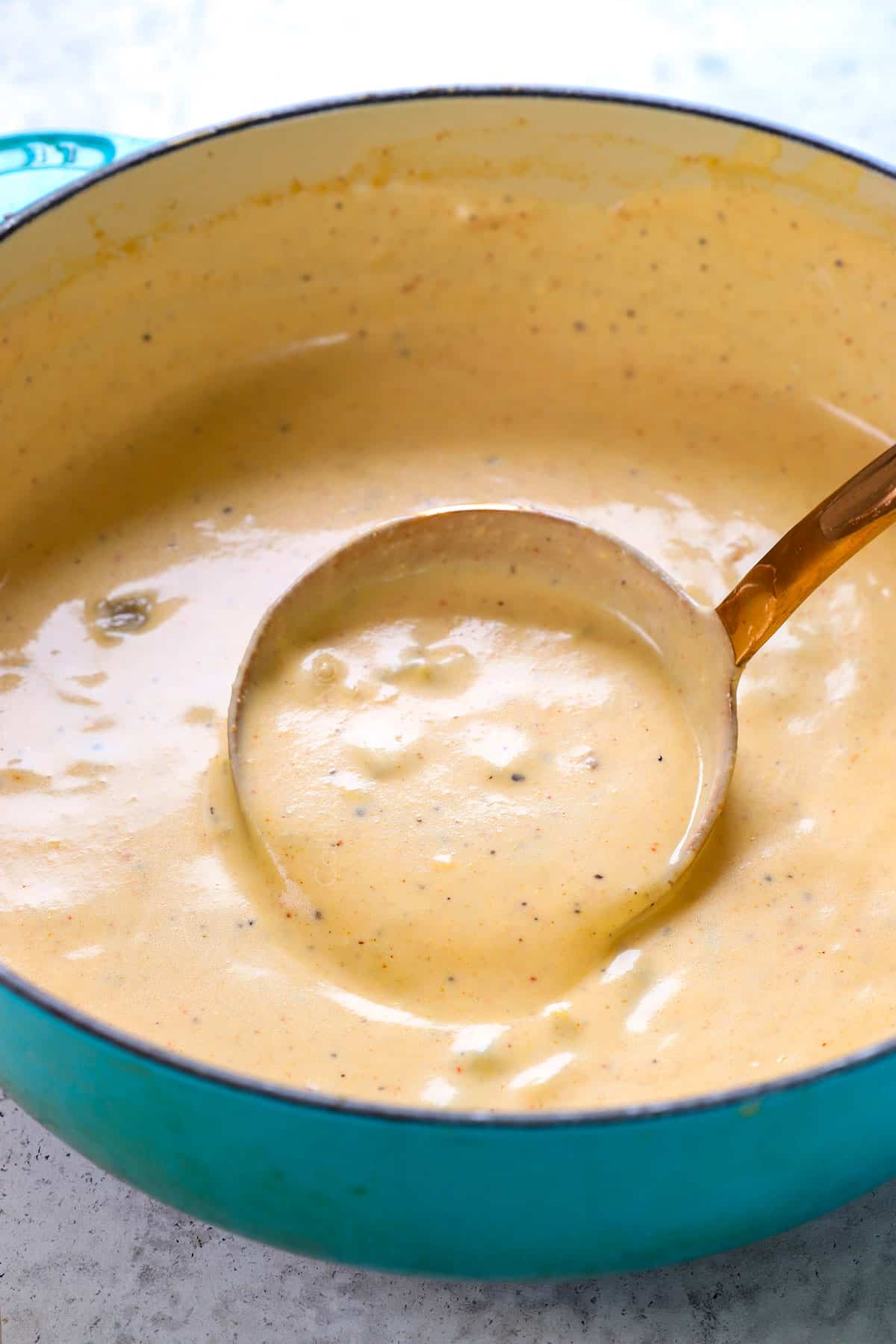 showing how to make totchos (tater tot nachos) by stirring nacho cheese sauce