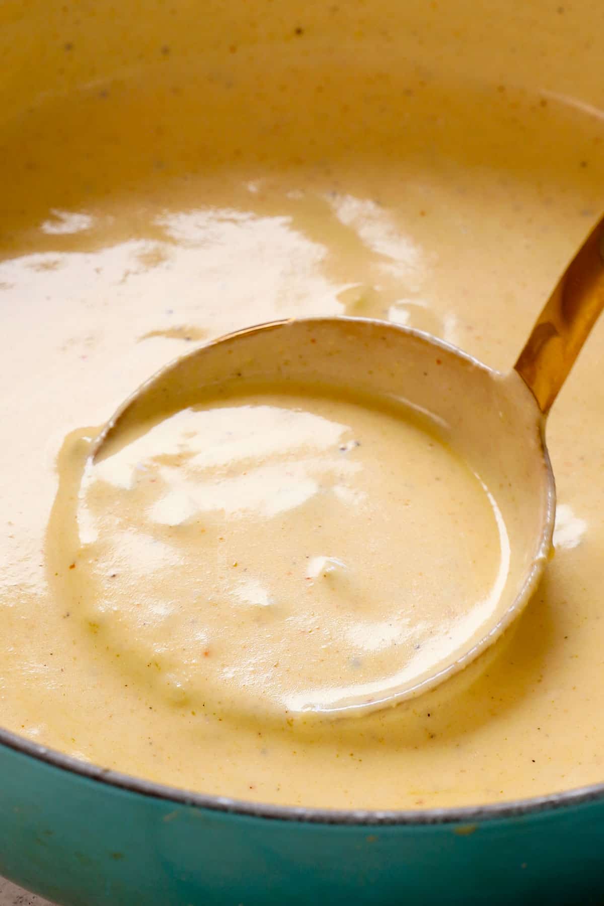 showing how to make chimichanga recipe with beef by spooning the sauce over top