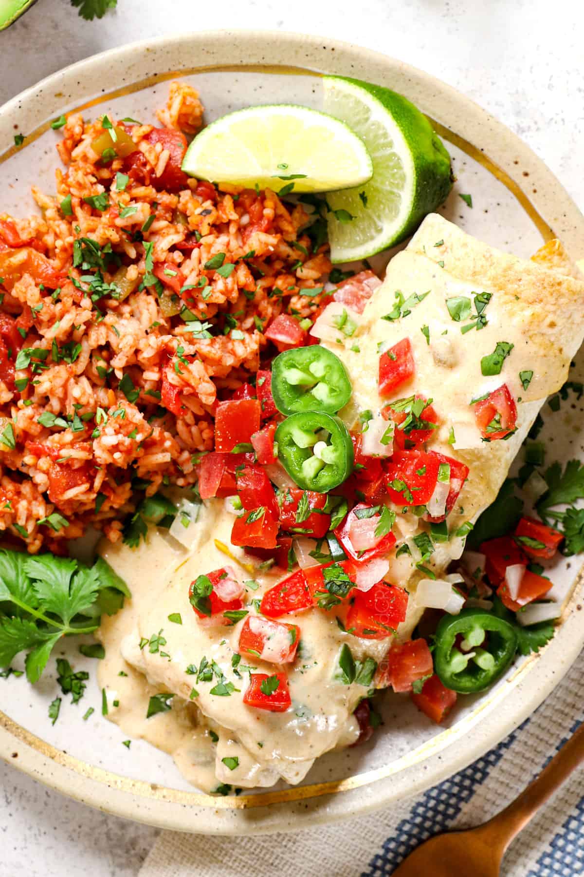 showing how to make chimichangas with beef by topping with sauce, pico de gallo and guacamole
