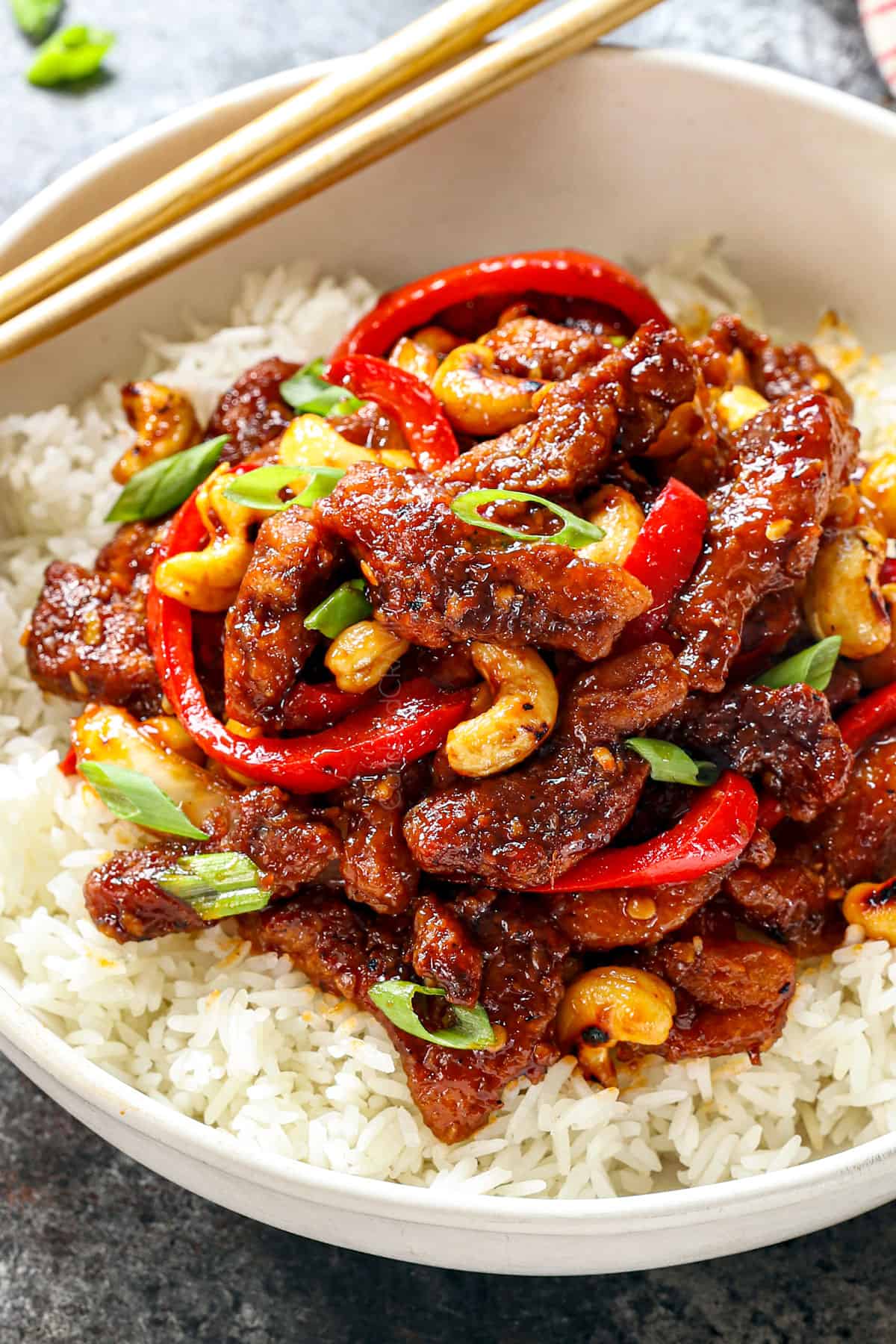 up close of serving Dragon Chicken in a bowl with rice showing how crispy the chicken is