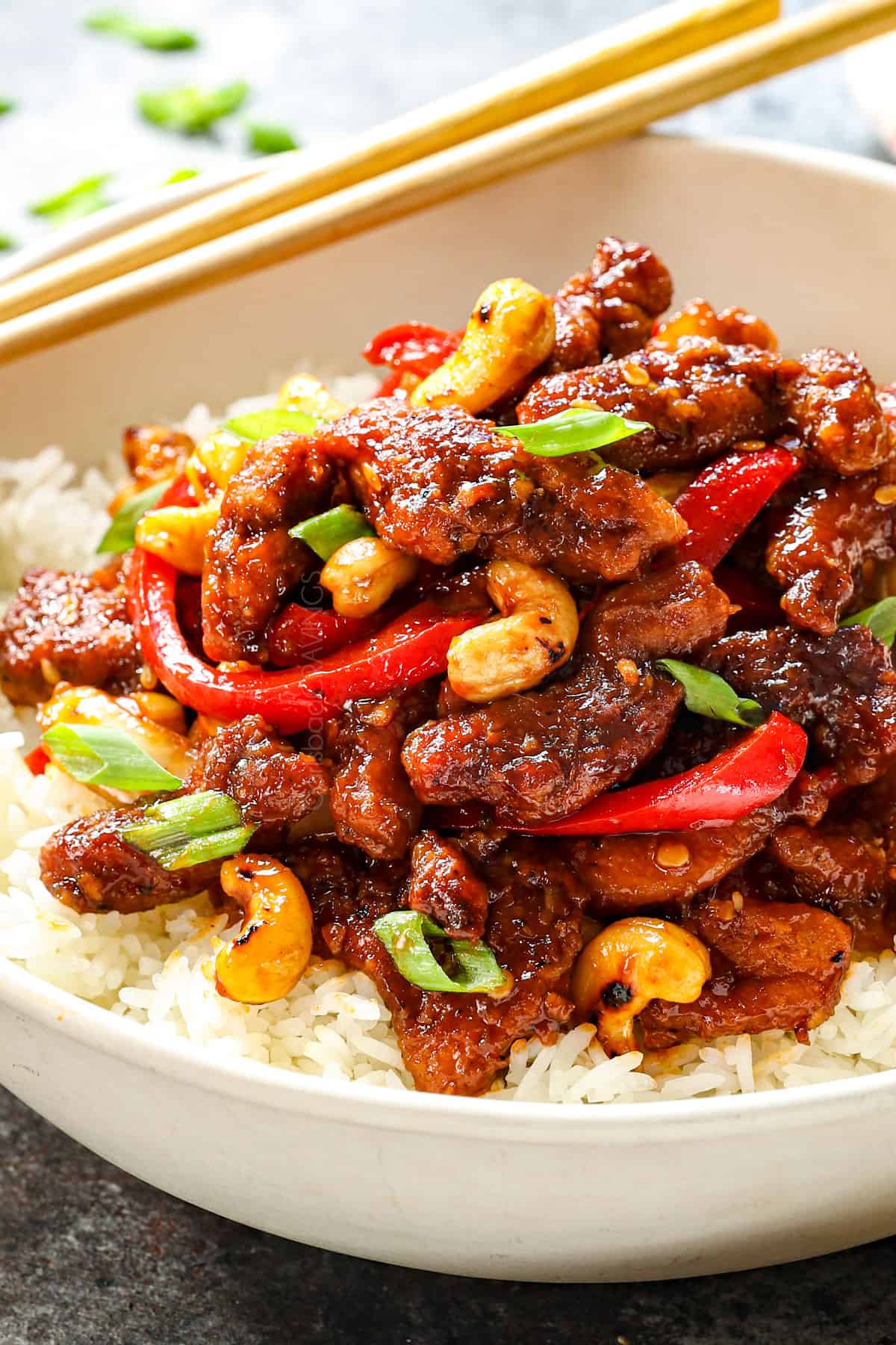 up close of serving Dragon Chicken in a bowl with rice showing how crispy the chicken is