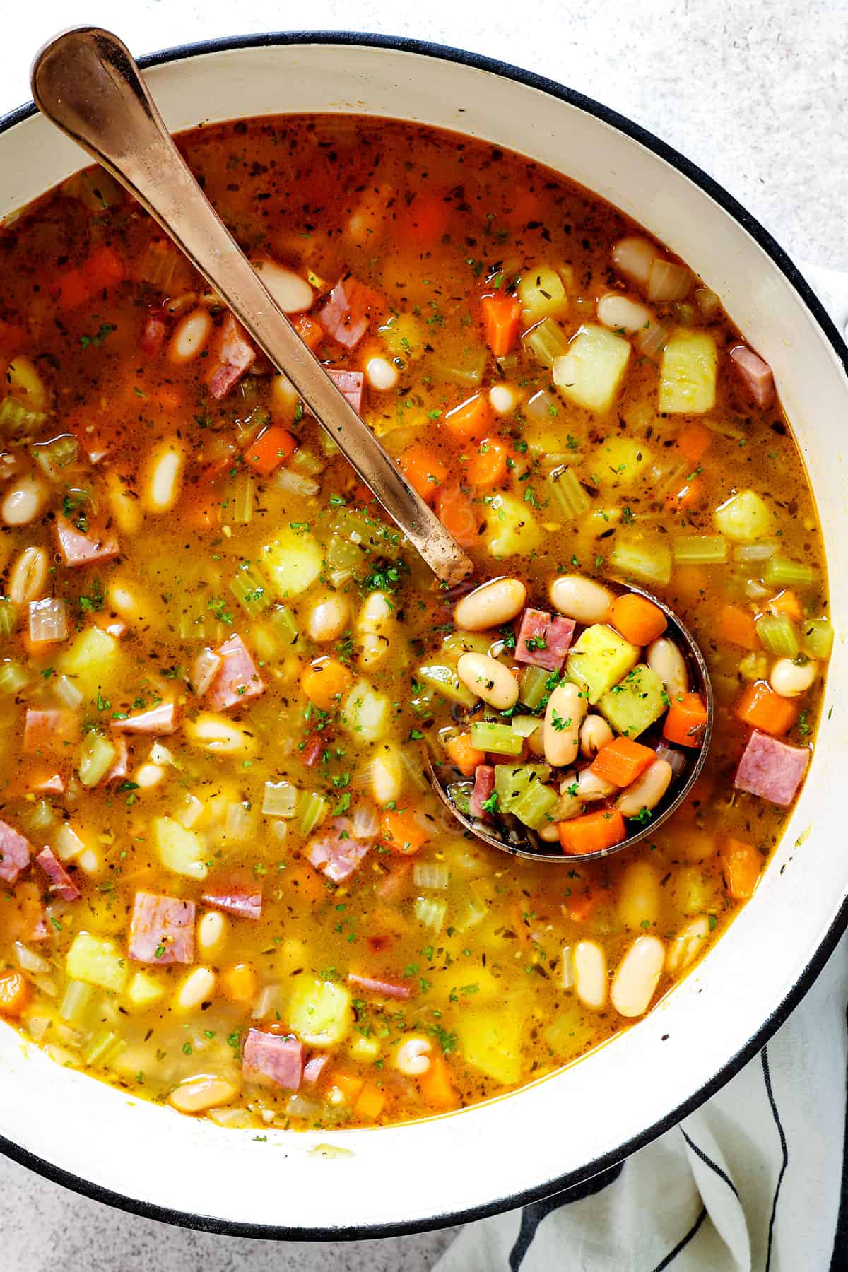 showing how to make bean and ham soup by simmering until the potatoes are tender