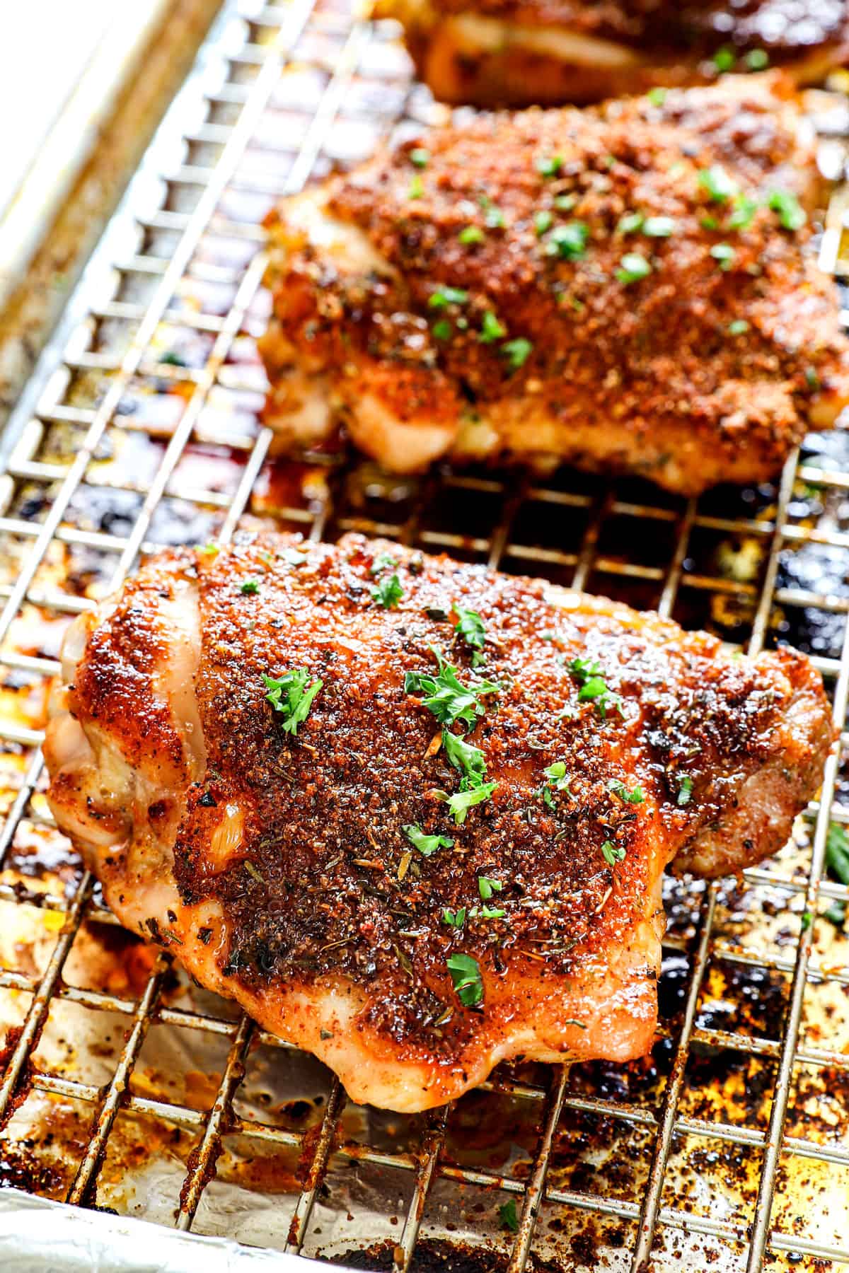 baked chicken thighs recipe on a baking sheet showing how crispy it is