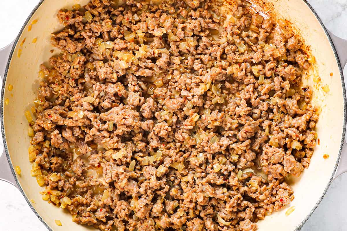 showing how to make easy lasagna in a skillet by browning sausage and onions