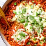 showing how to make skillet lasagna recipe by melting the mozzarella, ricotta and Parmesan in the oven