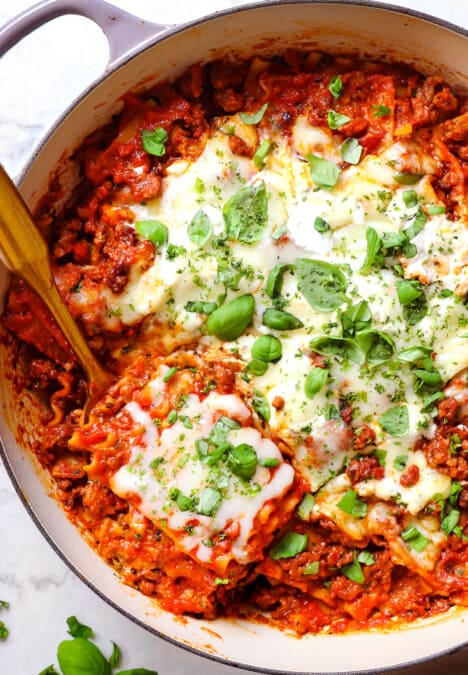 showing how to make skillet lasagna recipe by melting the mozzarella, ricotta and Parmesan in the oven