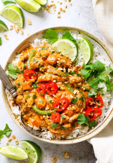 top view of crockpot curry chicken recipe made with coconut milk, red curry paste, fish sauce, soy sauce and lime juice, in a bowl serve over rice