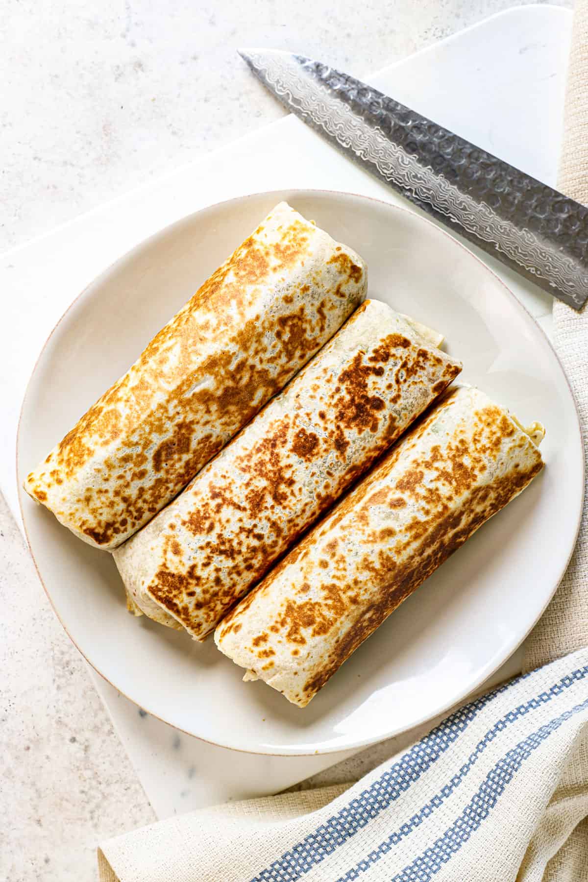 showing how to make chicken Caesar wrap crispy by toasting in a skillet