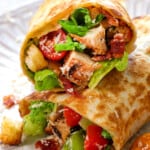 up close of Chicken Caesar Wrap showing the juicy chicken and crunchy lettuce