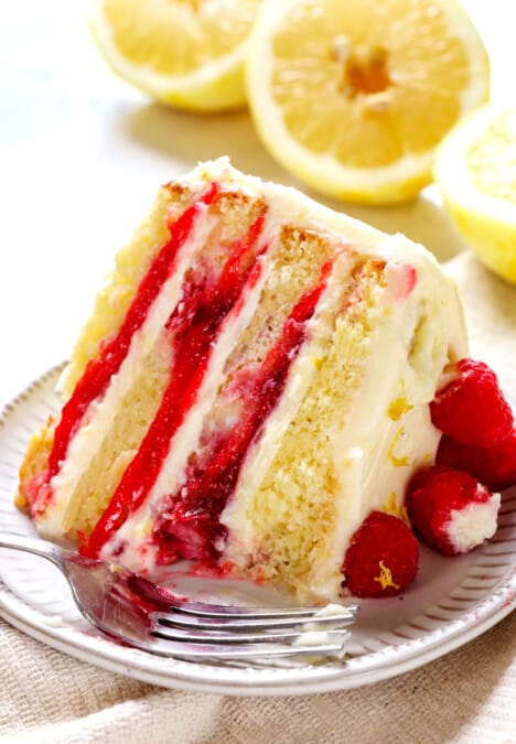 up close of a bite of of Raspberry Lemon Cake showing the raspberry filling and tender cake