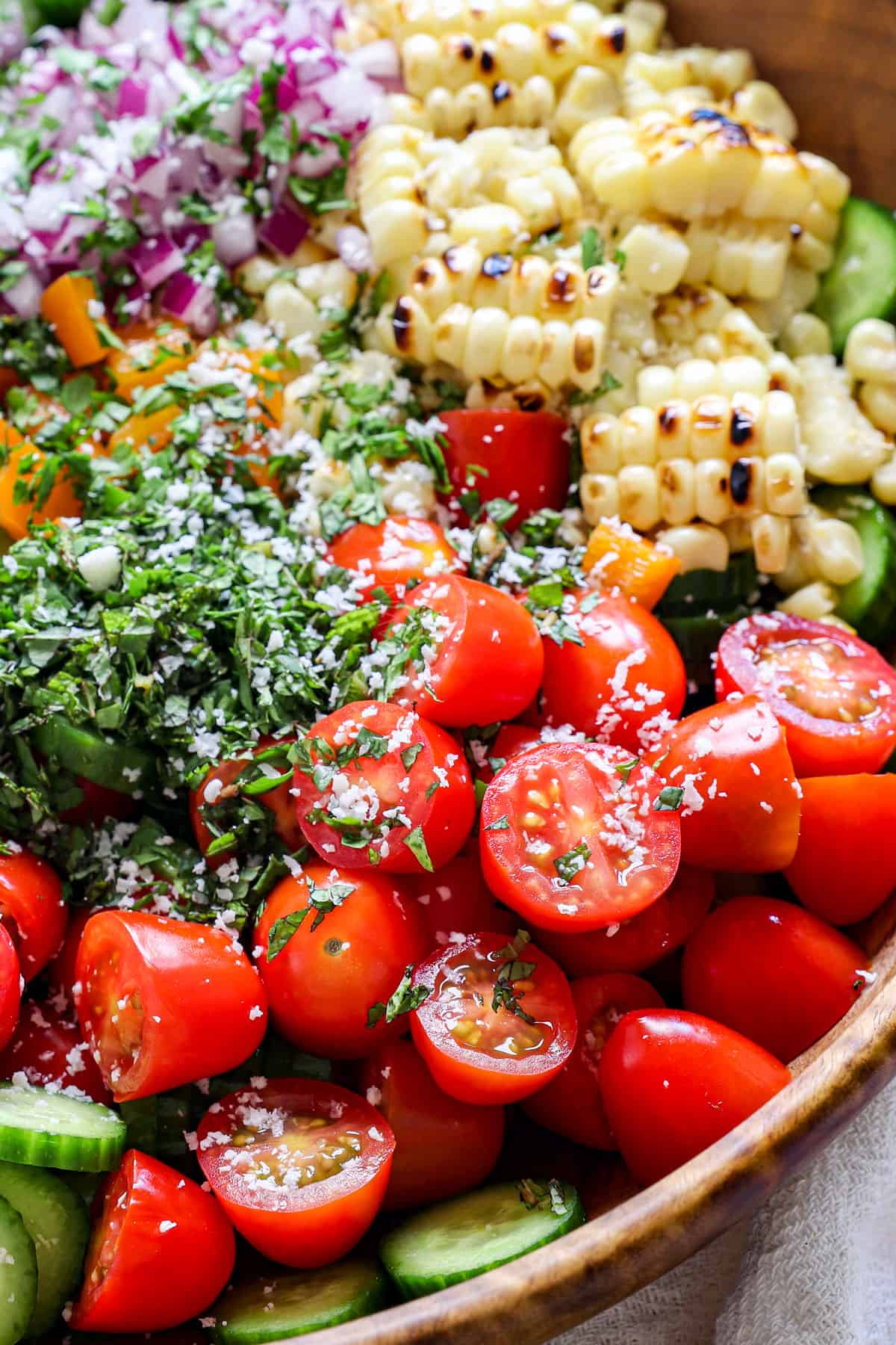 side view of a bowl showing ingredients for cucumber salad in a bowl