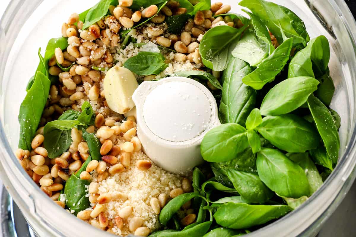 showing how to make red potato salad by adding pesto dressing ingredients to a food processor