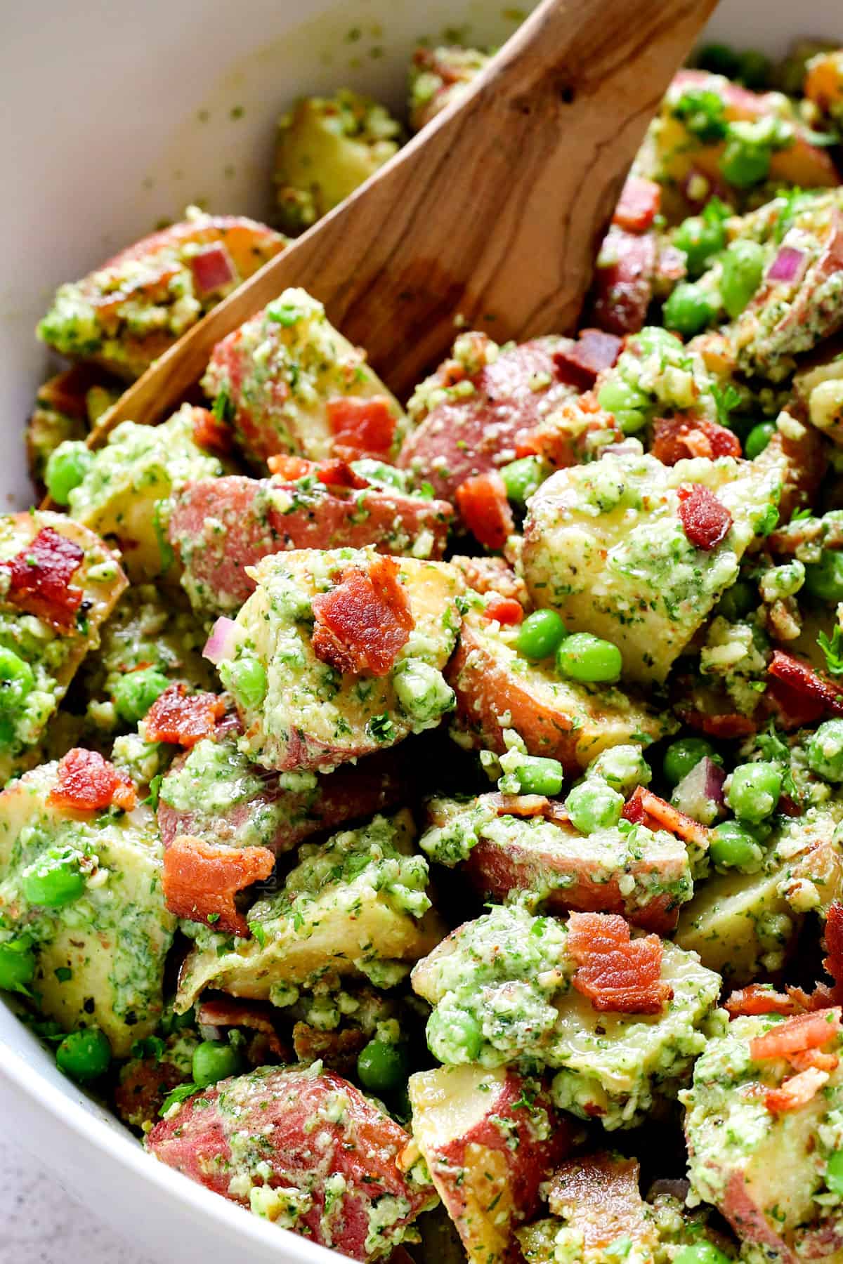 up close of red potato salad recipe in a bowl showing the creamy dressing