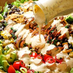 showing how to serve chipotle dressing by pouring over a salad