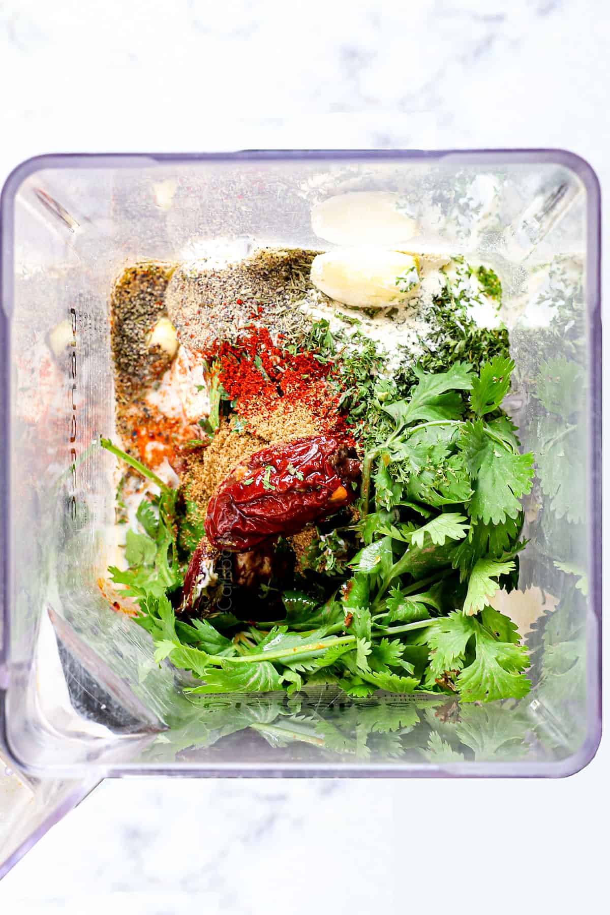 showing the ingredients for chipotle ranch dressing by adding them to the blender