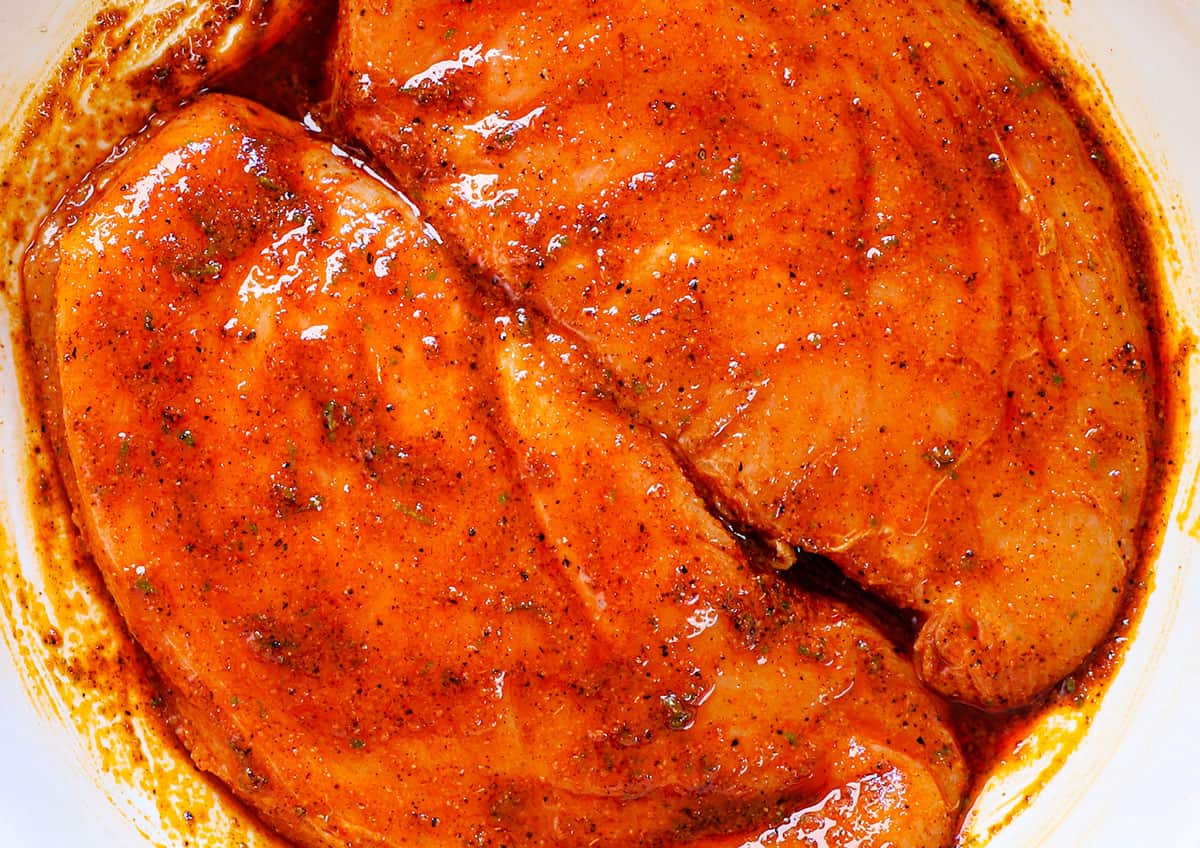 showing how to make Southwest Chicken Salad by marinating the chicken