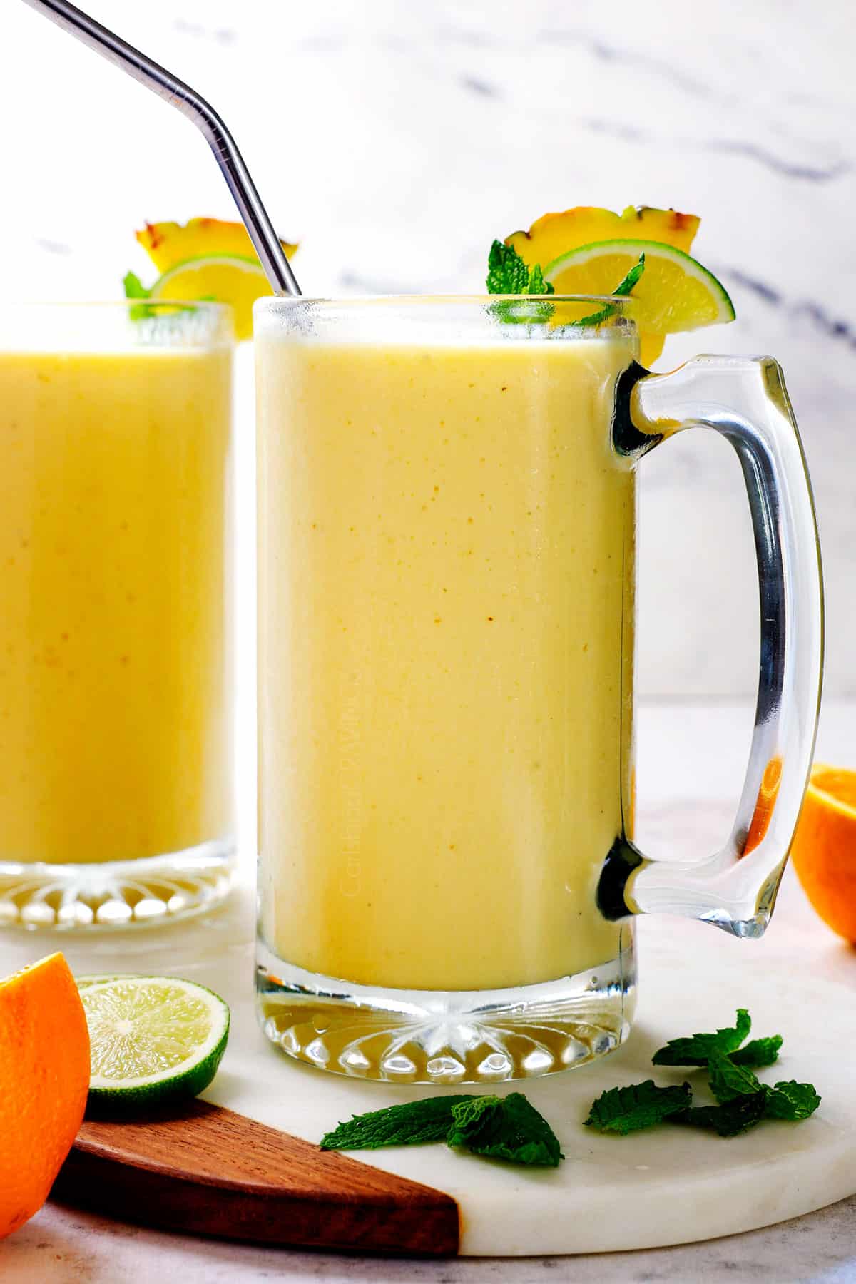 Showing how to serve Tropical Smoothie poured into two large glasses