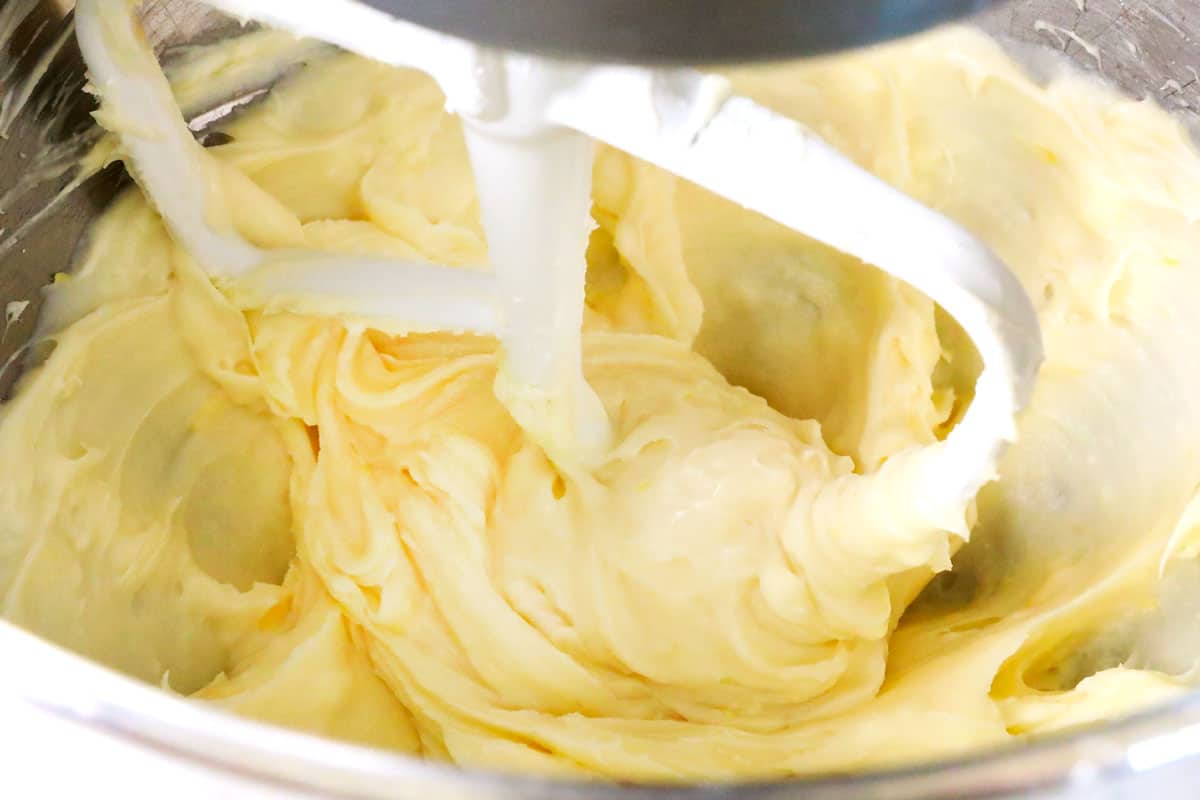 showing how to make fruit pizza recipe by making cream cheese frosting in a mixer