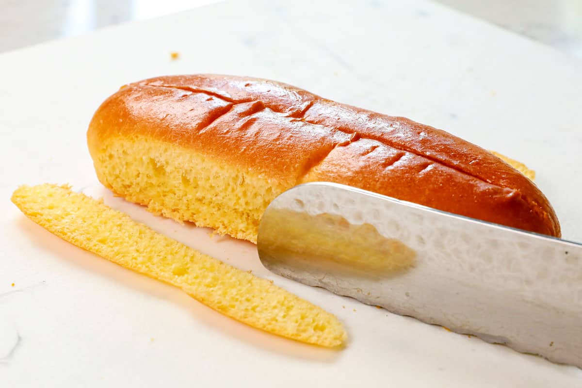 showing how to make a lobster roll by slicing the sides of the buns and toasting in butter in a skillet