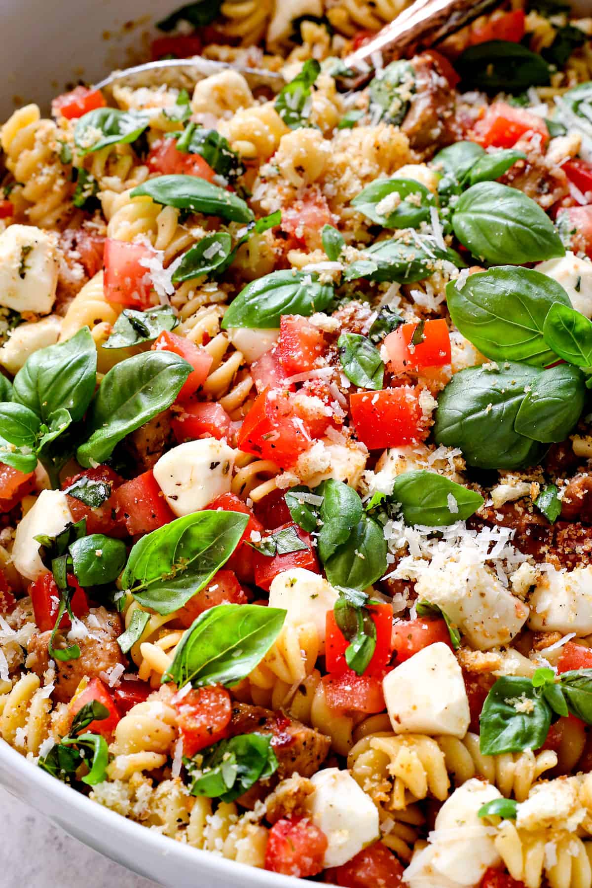 up close of chicken pasta salad recipe showing the ingredients tossed with the dressing