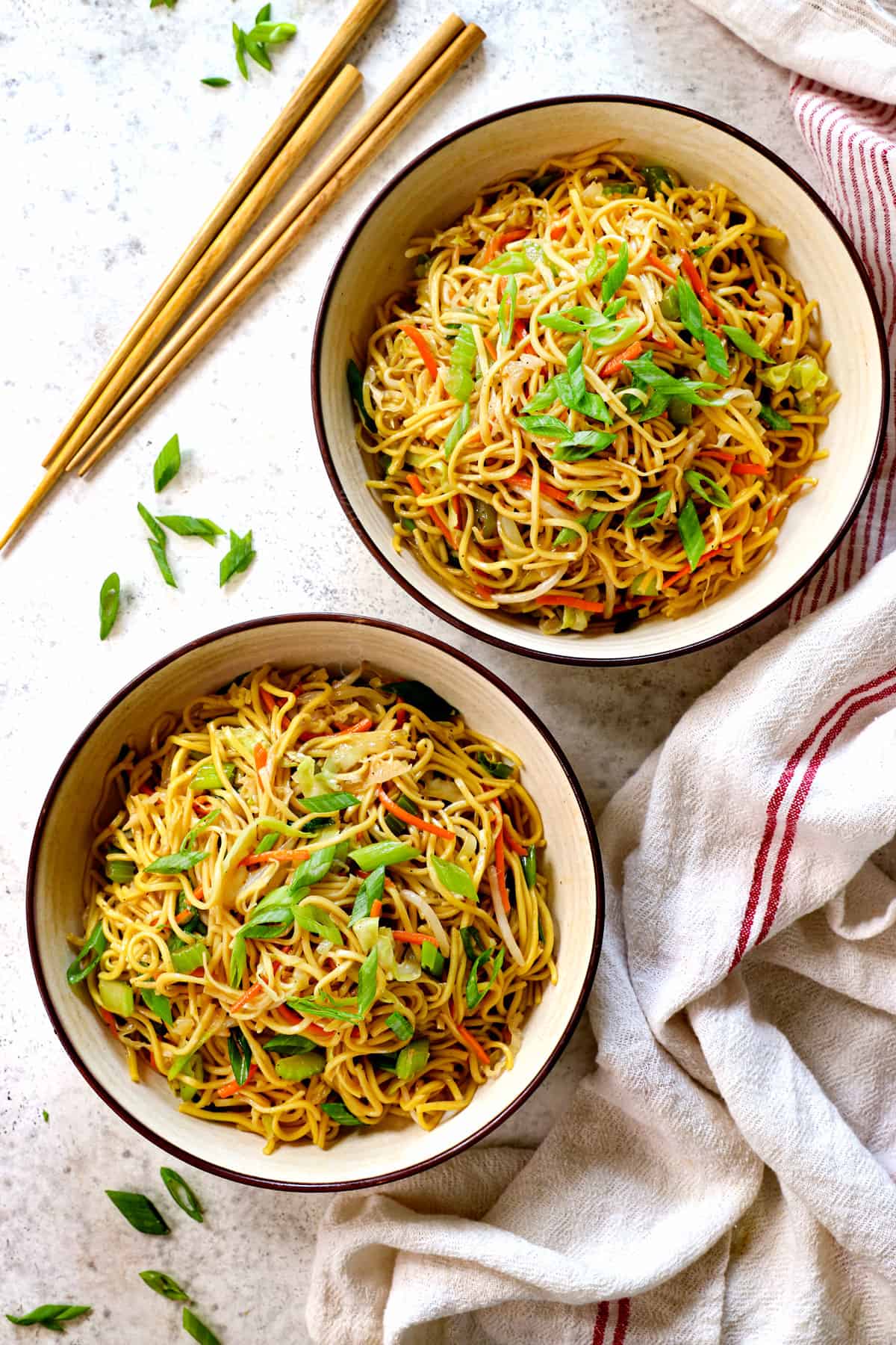 serving chow mein noodles recipe in two bowls with chopsticks