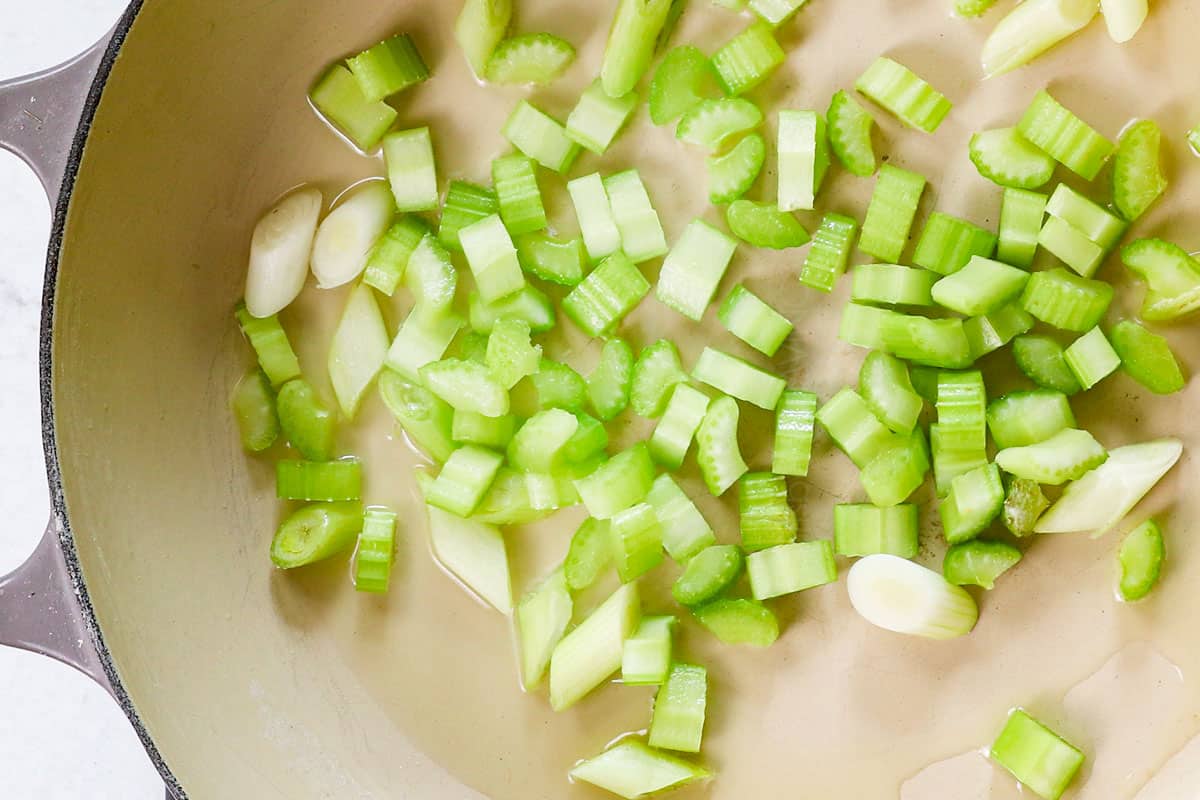 showing how to make chow mein by stir frying green onions and celery