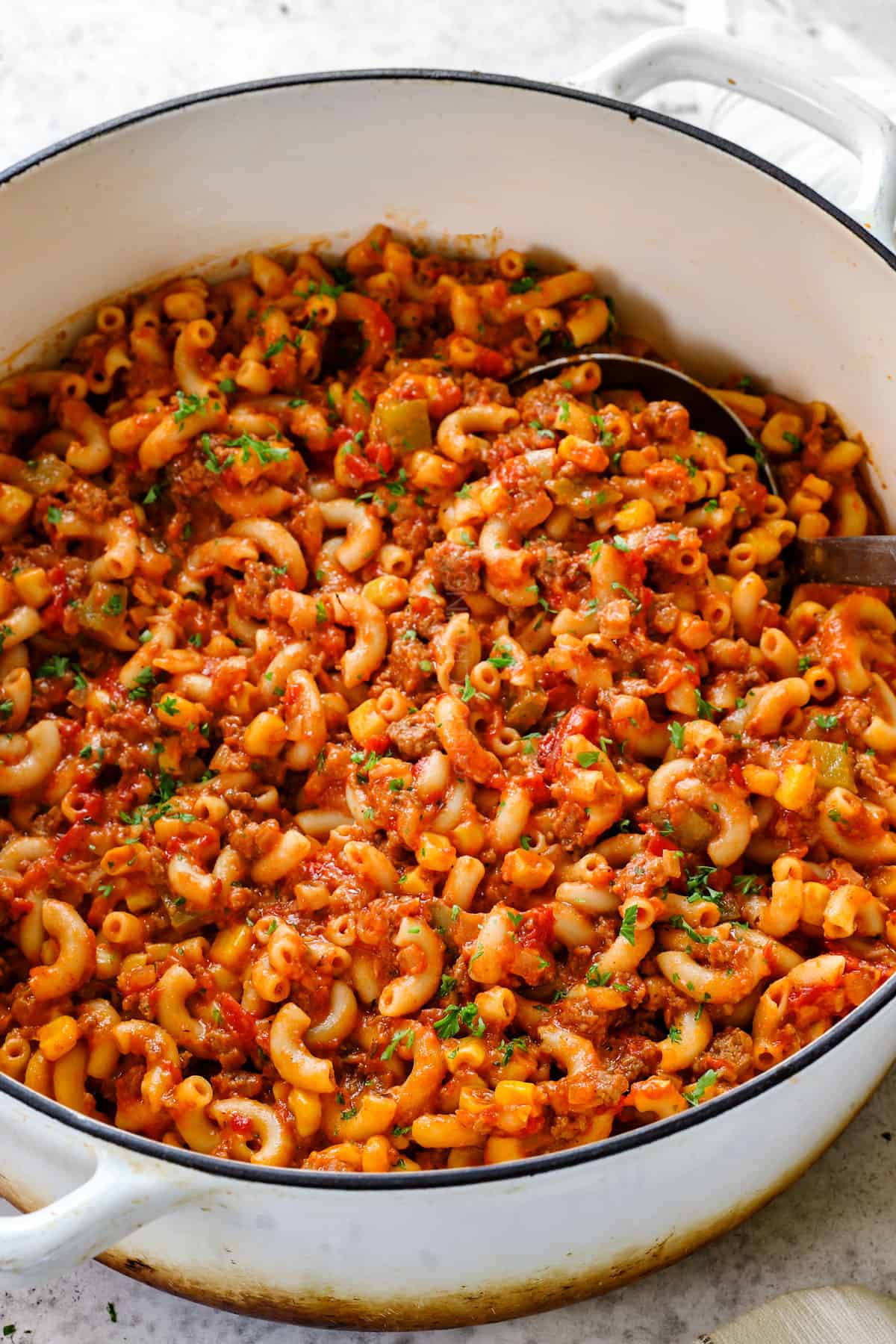 a pot of goulash (American Chop Suey) with macaroni, ground beef, tomatoes, bell peppers, onions and tomato sauce