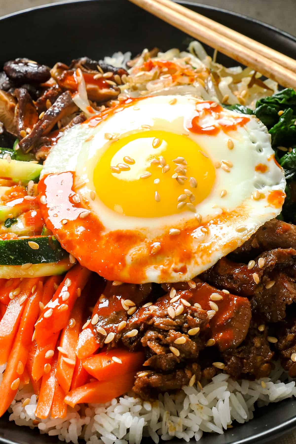 up close of sunny side egg on bibimbap