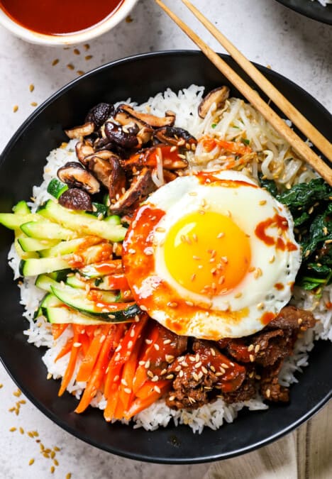 top view of bibimbap showing how to assemble the bowls with rice, vegetables and beef