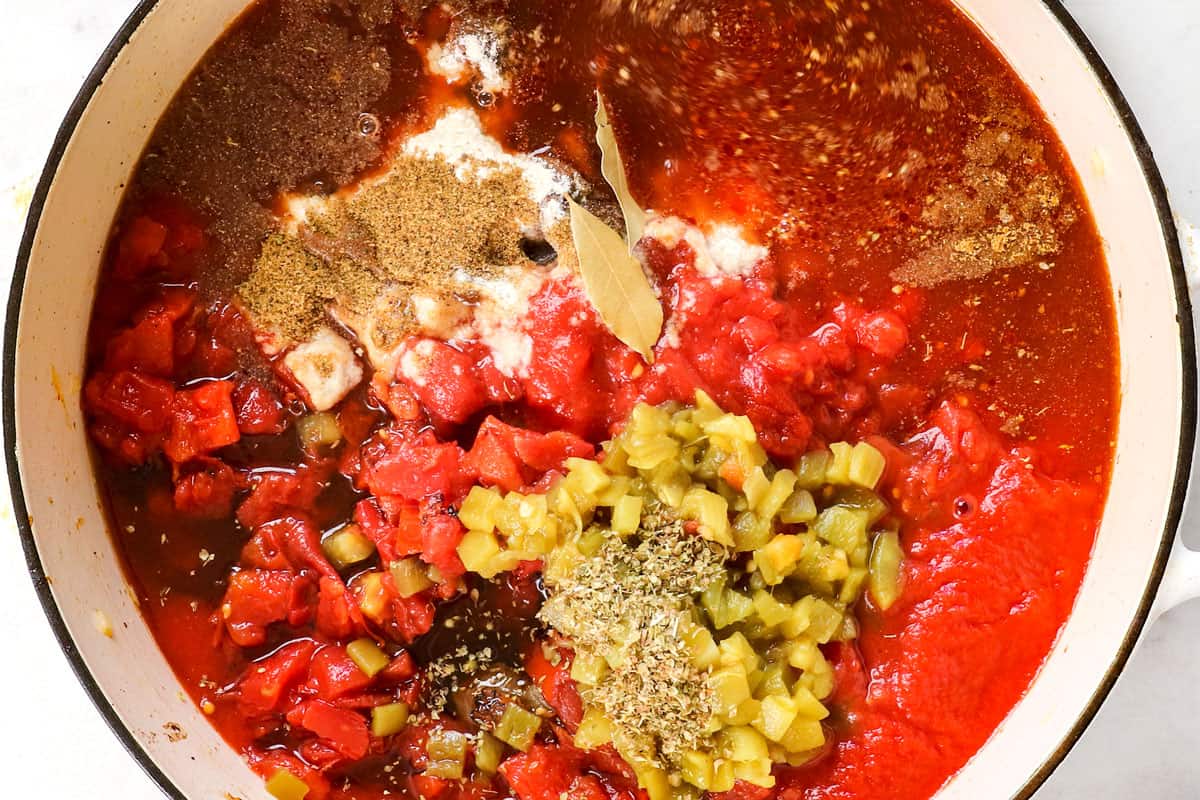 showing how to make chili con carne (beef chili) by adding tomatoes, green chilies and broth to the pot