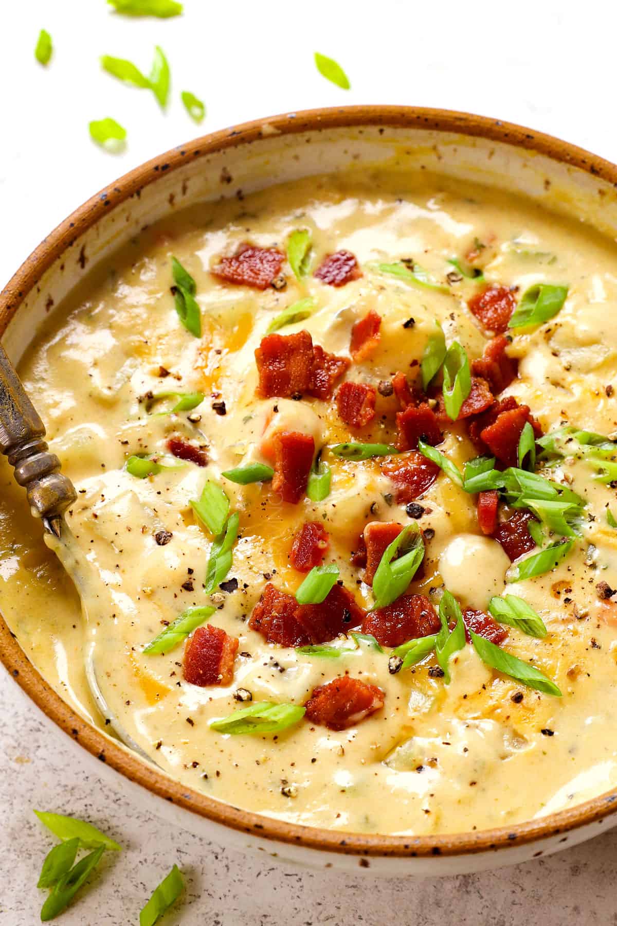 up close of a spoonful of potato soup recipe in a bowl showing how thick and creamy it is