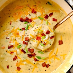 top view of best best potato soup recipe with a ladle spooning the soup