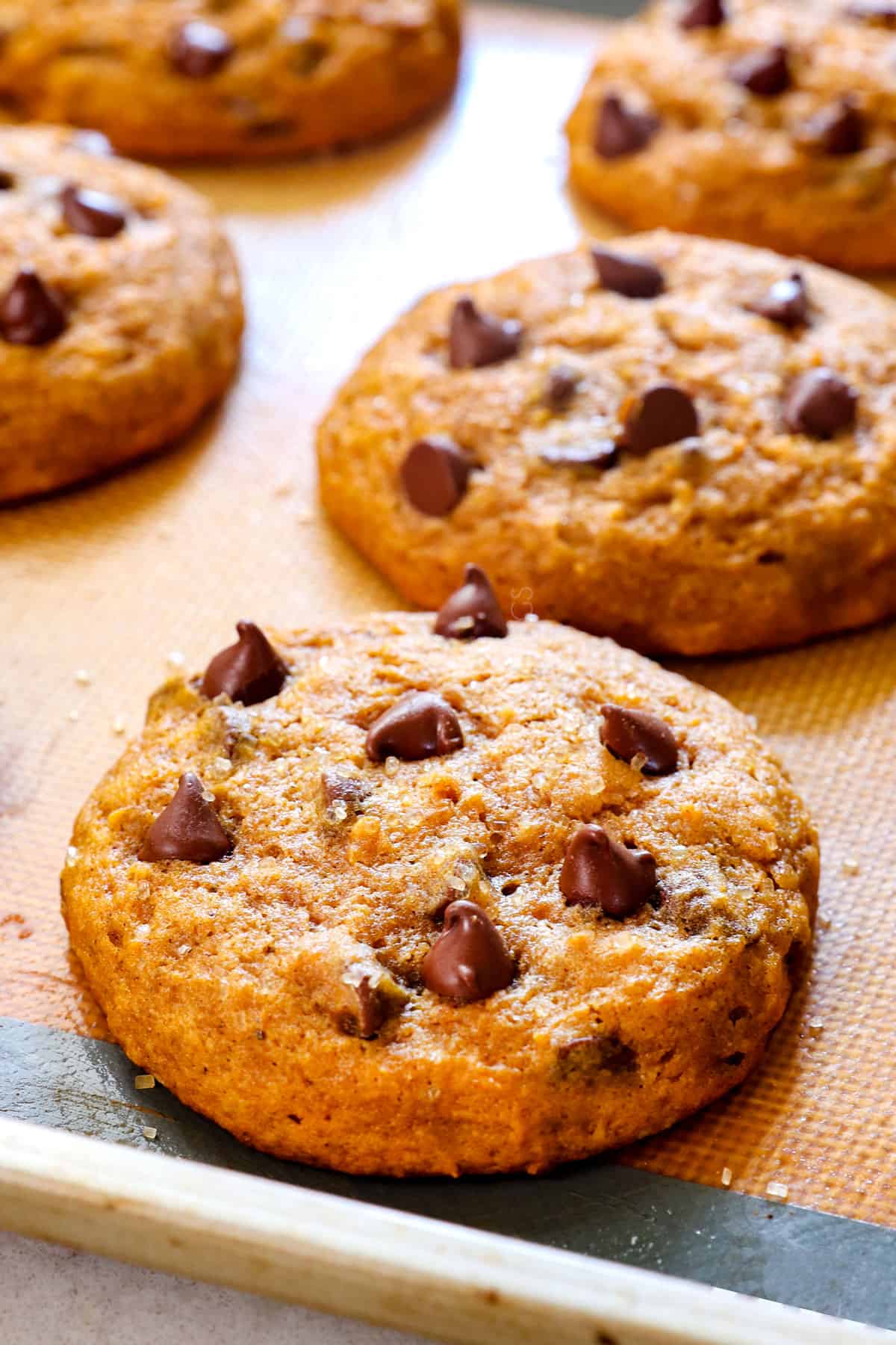 up close of pumpkin chocolate chip cookies recipe on a baking sheet showing how to bake on a nonstick mat